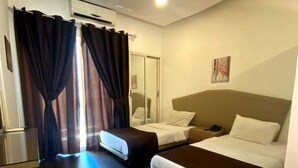 A hotel room with two beds, a wooden floor, a mirror, and a painting on the wall. - Dreams Suites (Beirut)