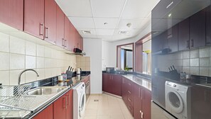 Exclusive Apartment, Balcony, Canal View | Private kitchen | Fridge, microwave, oven, stovetop - WelHome - Stunning High-Rise with Canal View Near MarinaMall (Dubai)