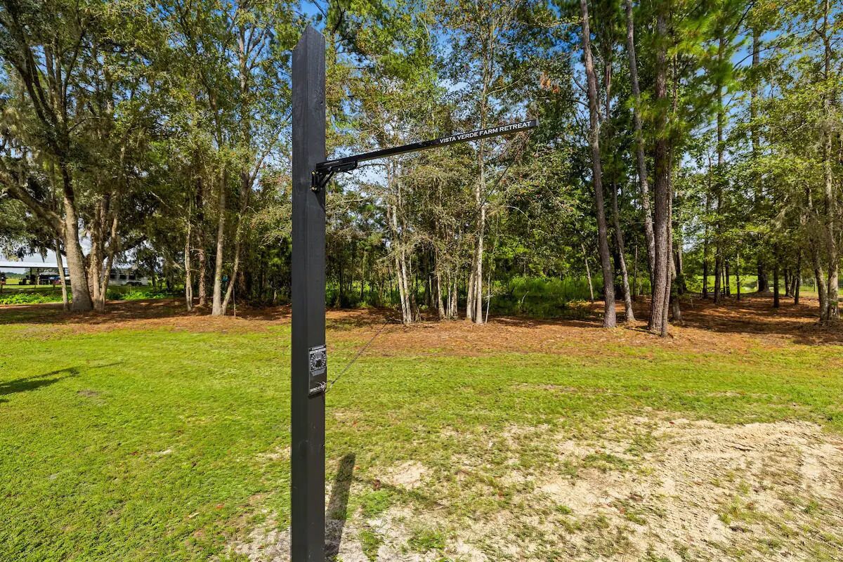 A black metal structure with a sign reading "Vista Verde Farm Retreat."