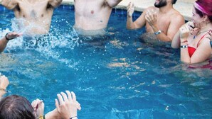 A swimming pool with people enjoying themselves.