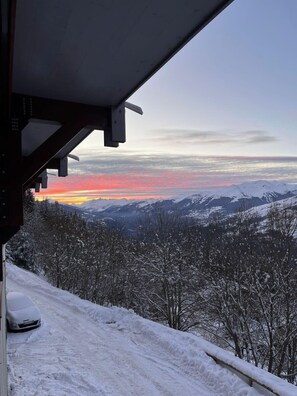 A snowy mountain landscape with a sunset.