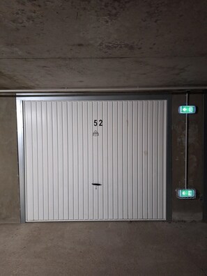 A closed, white, vertical-striped door with the number 52 and a keyhole.