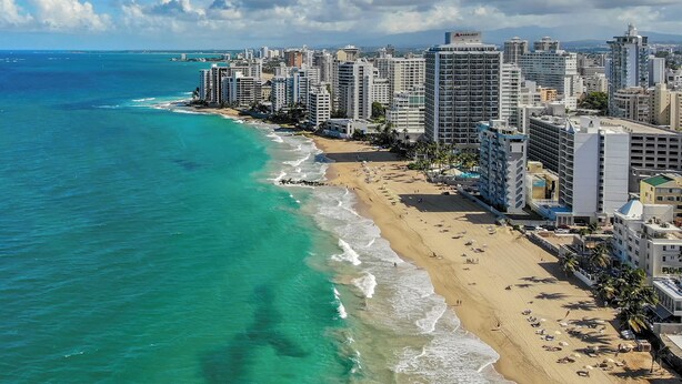 A coastal cityscape with a beach, high-rise buildings, and clear skies. - New! Penthouse Studio C in heart of Condado (San Juan)