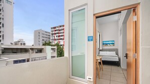 A hotel room with a bed, a small table, and a painting on the wall. - New! Penthouse Studio C in heart of Condado (San Juan)
