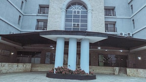 A building with the sign "FULLMOON" above the entrance. - Fullmoon Hotels Owerri (Owerri)