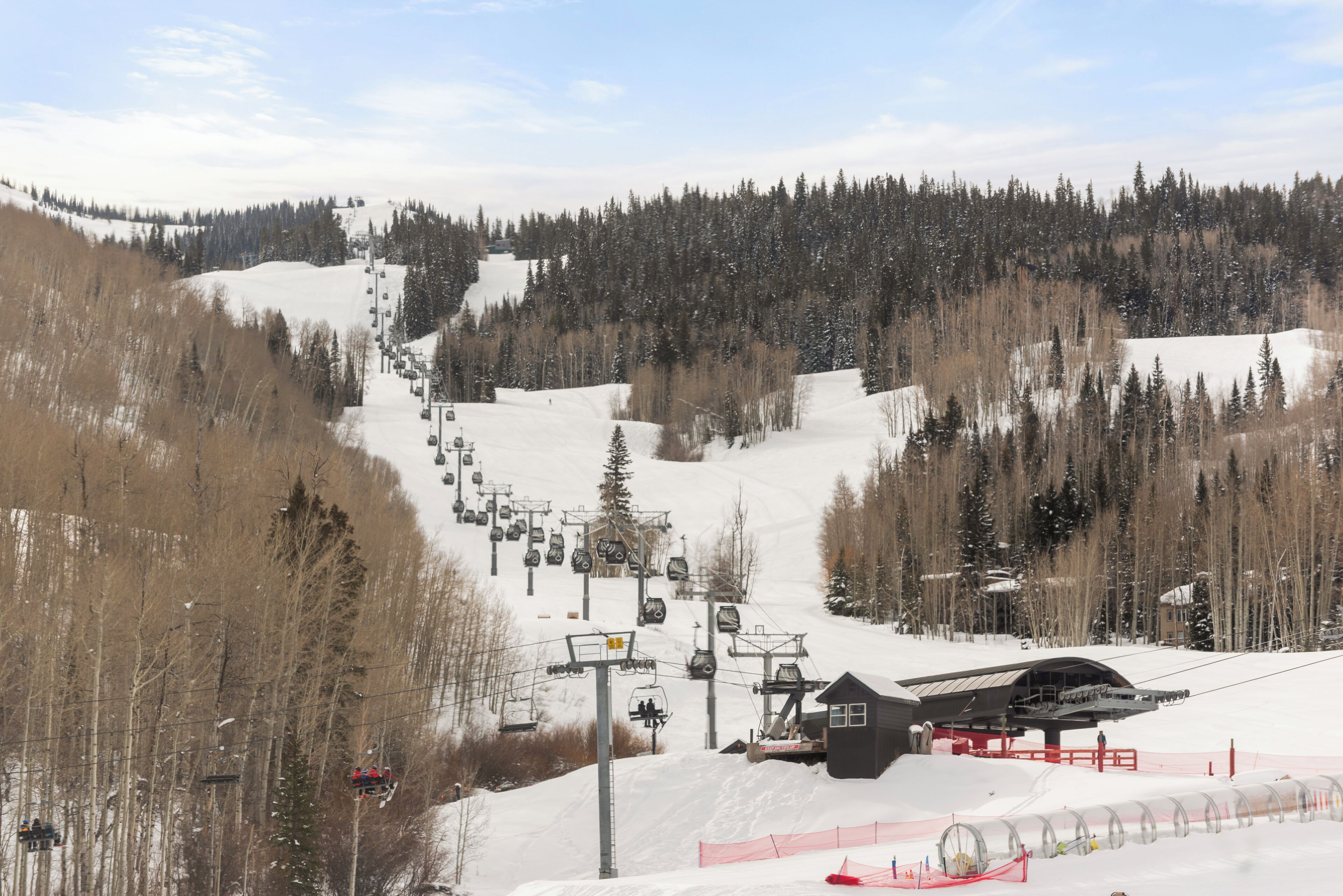 A ski resort with a chairlift, snow-covered slopes, and a lodge.