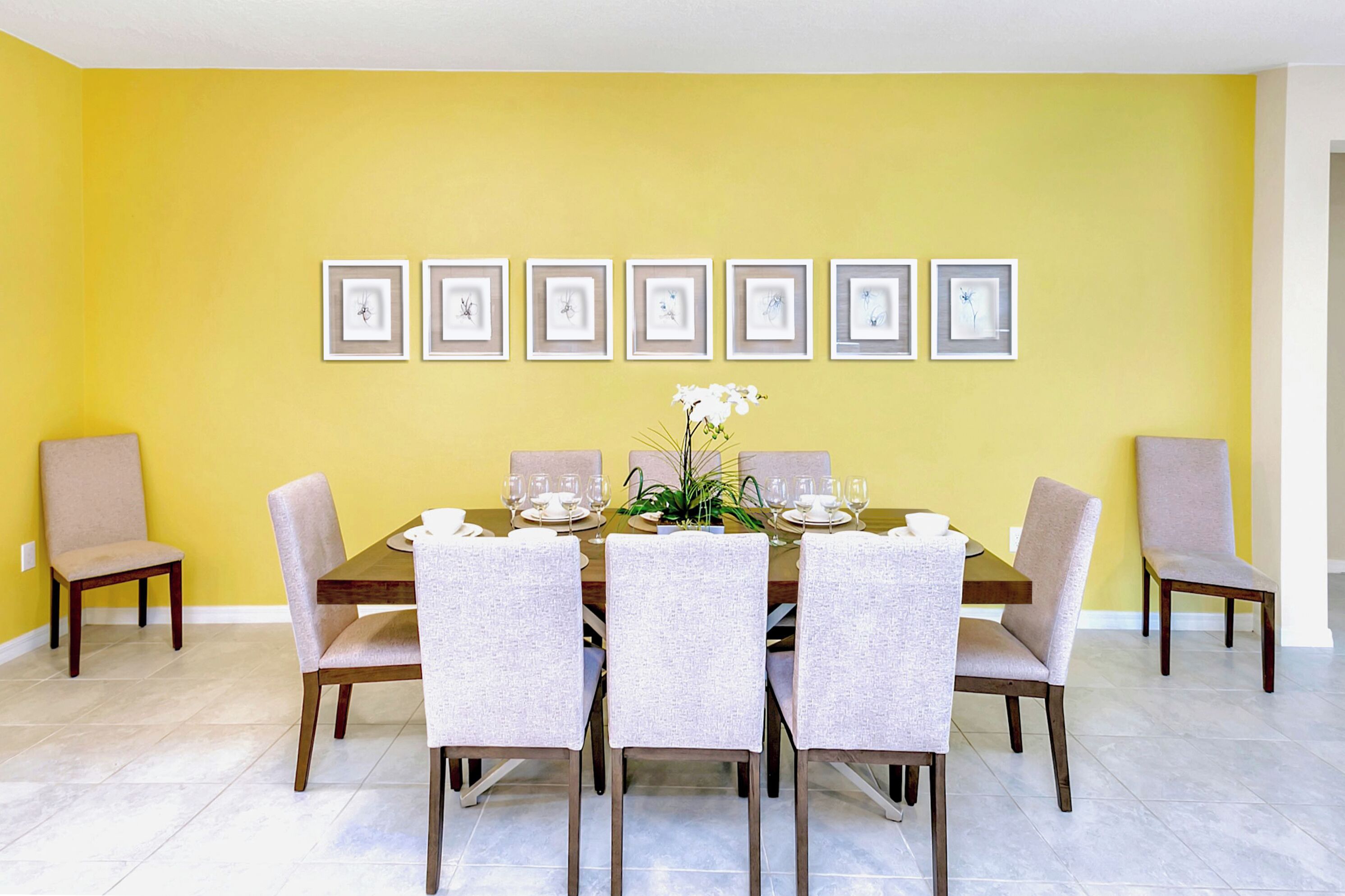 A dining room with a yellow wall, a wooden table, and six chairs.