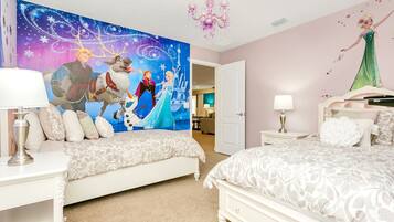 A bedroom with two beds, a large wall mural, and a chandelier.