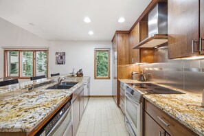 A modern kitchen with granite countertops, stainless steel appliances, and wooden cabinets. - Ski in/Ski out Luxury Penthouse Condo, Hot Tub,  Walk to Village in Beaver Creek (Beaver Creek)