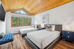 A bedroom with two beds, a large window, a ceiling fan, and a TV. - Ski in/Ski out Luxury Penthouse Condo, Hot Tub,  Walk to Village in Beaver Creek (Beaver Creek)