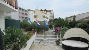 A courtyard with stone flooring, outdoor seating, and flags. - Double Room with Balcony 1 (Omis)