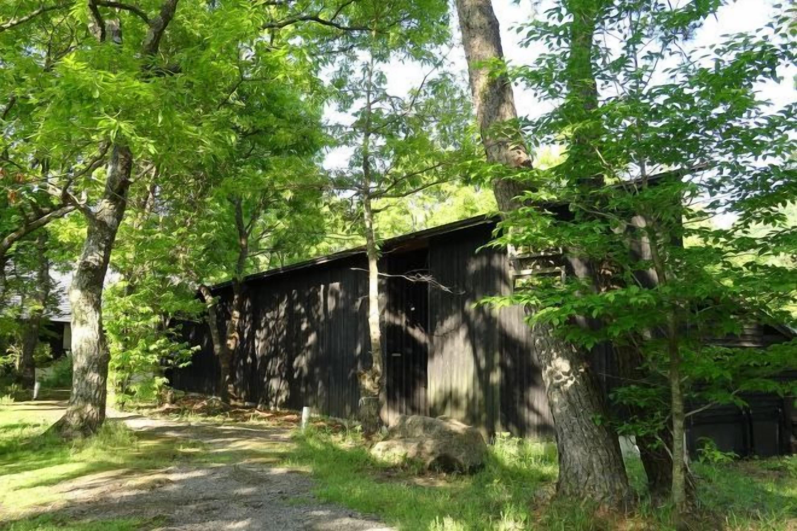 A rustic wooden building surrounded by trees.