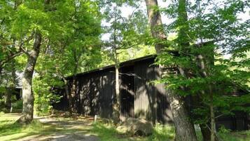 A rustic wooden building surrounded by trees.