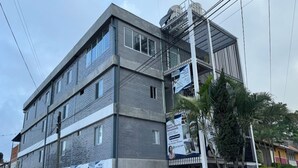 A multi-story building with a modern design, featuring a mix of brick and concrete materials.