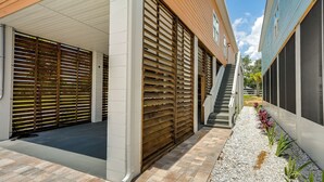A modern building with a covered parking area, a staircase, and a pathway lined with plants. - ~ 2 Mi to Boat Ramp: Steinhatchee River Cottage (Steinhatchee)