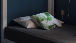 A bunk bed with a pillow on the lower bunk. - Experiencia Surf Camp (Brisas de Zicatela)