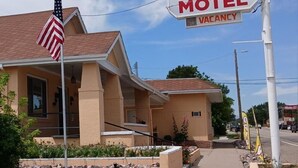 Un motel llamado 'Sands Motel' con un letrero que indica 'DISPONIBLE'.