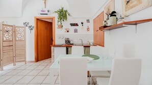 Una cocina moderna con puerta de madera, paredes blancas y suelo de baldosas.