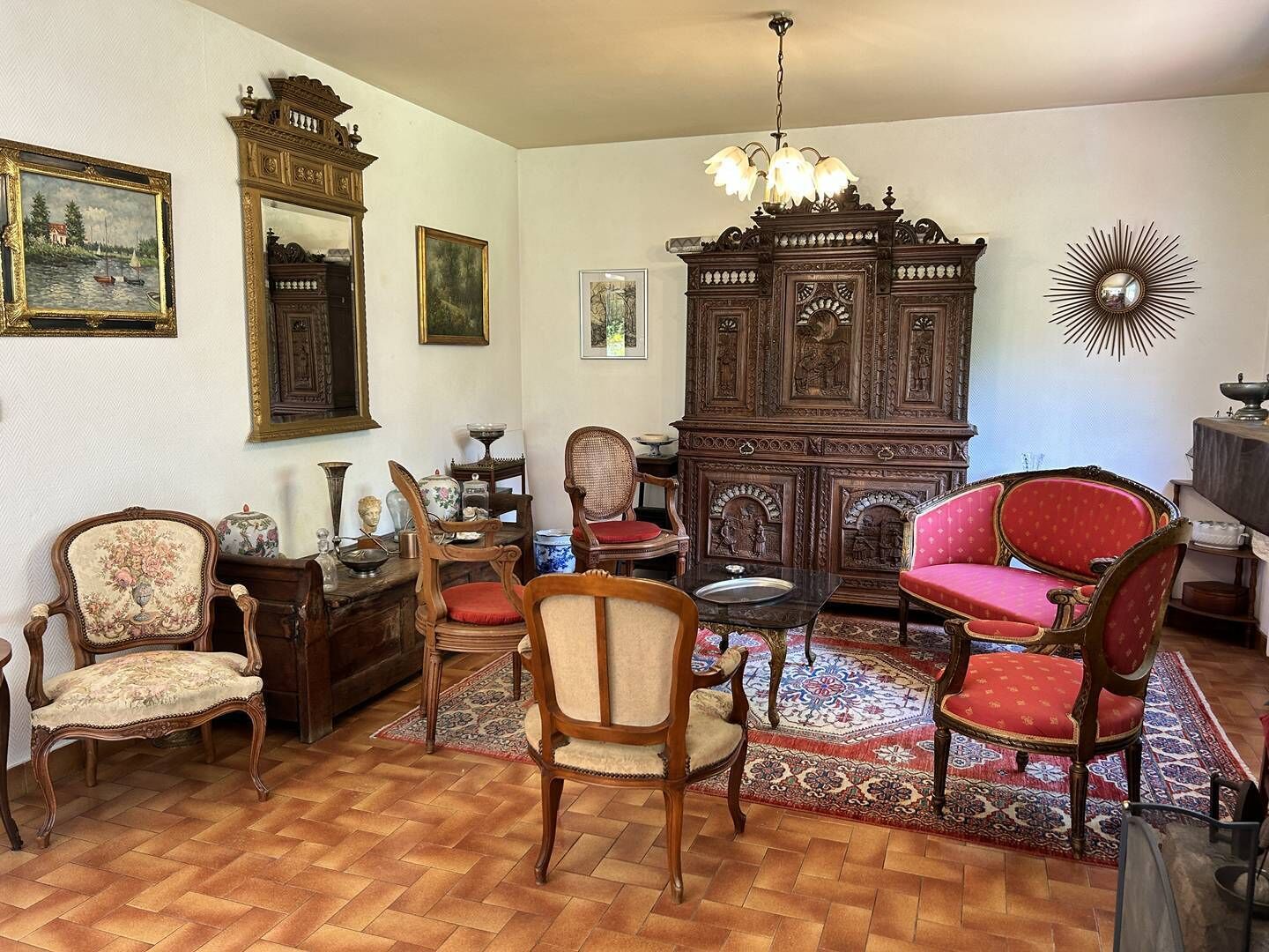 A traditional room with wooden furniture, a large cabinet, and a chandelier.