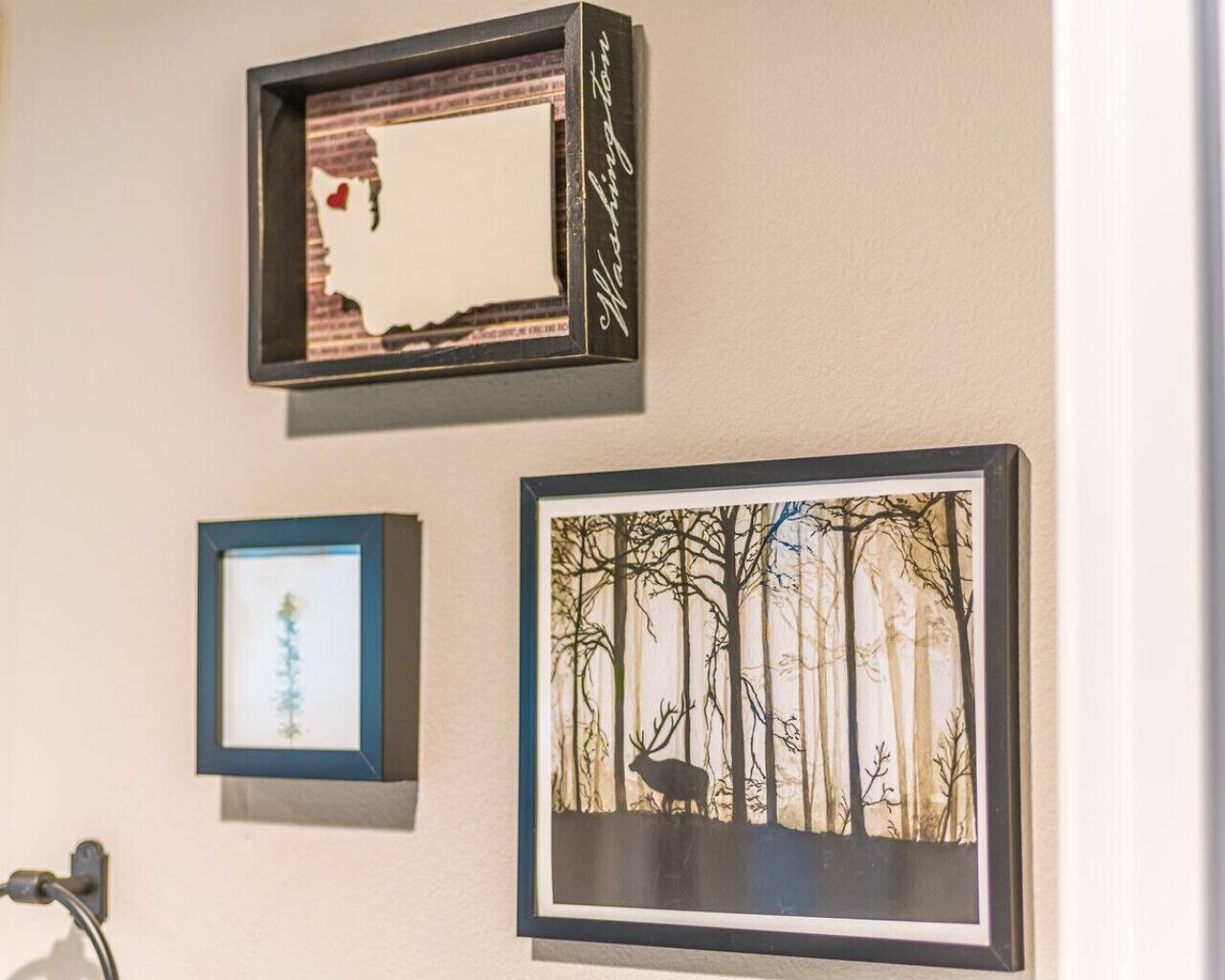 Three framed artworks on a wall.