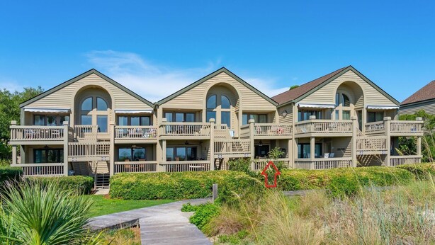 A three-story hotel with balconies, a wooden deck, and a clear sky. - Quaint Oceanfront, Pets ok, Pools, Golf, Amenity card! 1389 Pelican Watch (Seabrook Island)