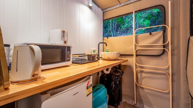 A compact kitchenette with a microwave, kettle, and small sink. - Queen tent 10 Nelly bay (Nelly Bay)