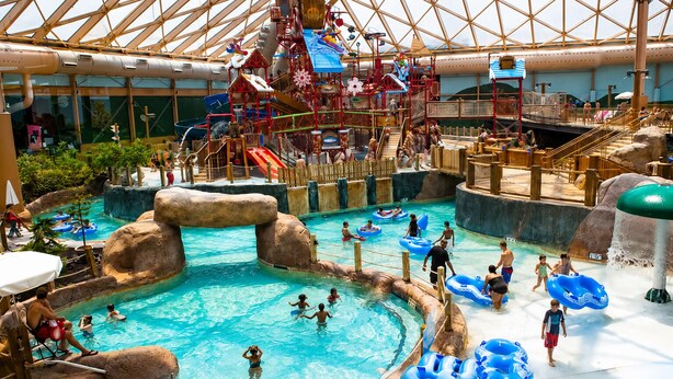 An indoor water park with multiple pools, slides, and water play areas. - 8-Person HotTub, Family&Group Friendly, EV Charger, Free Platinum Pool Pass (Mc Gaheysville)