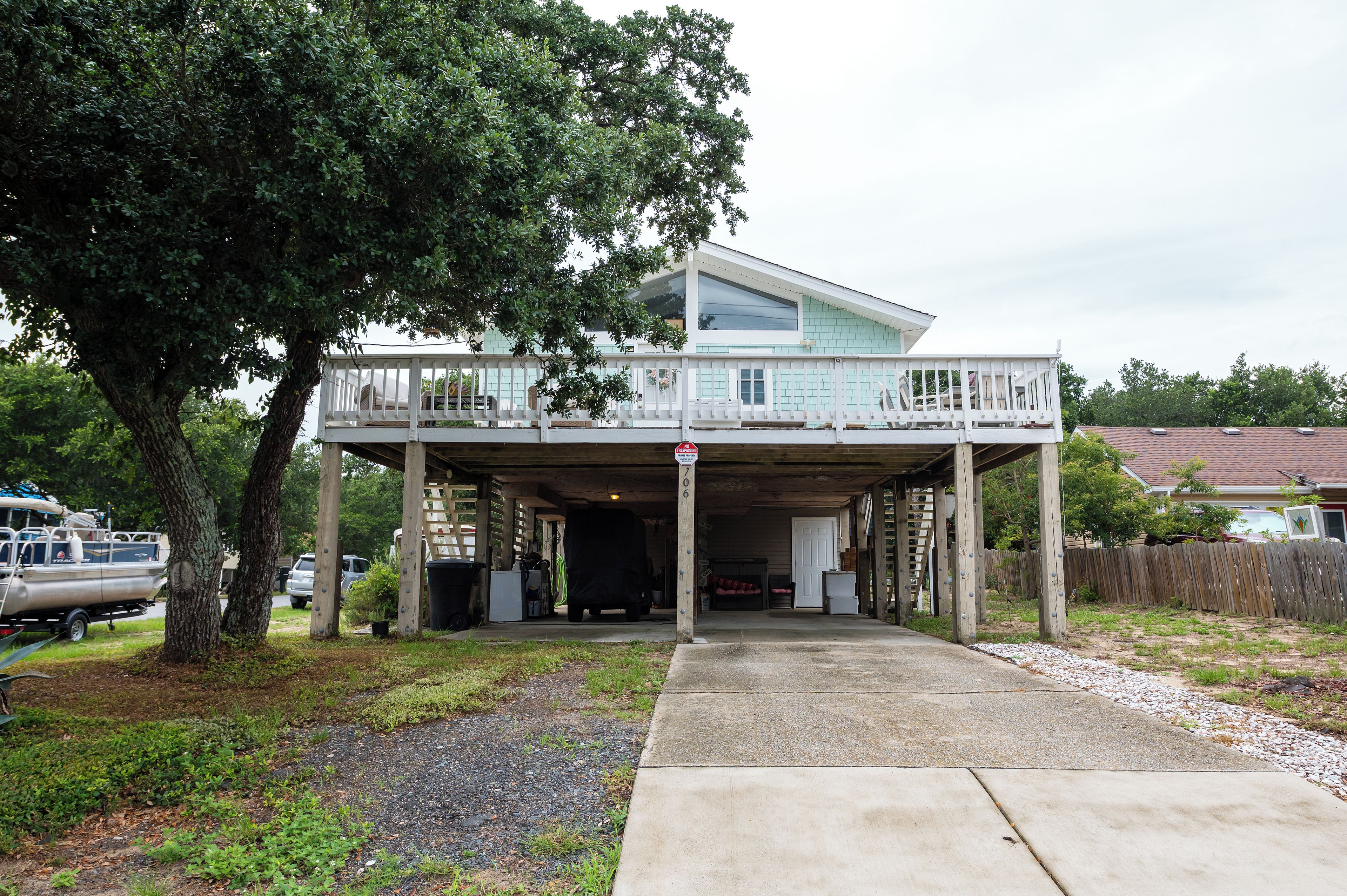 A two-story house with a covered garage and a balcony.