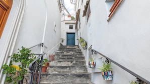 A narrow stairway with stone steps leading to a door at the top.