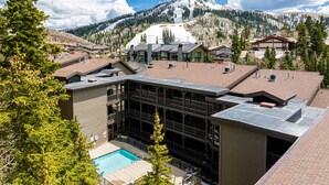 A hotel with a pool, multiple floors, and a mountain view. - World-class Ski spot + Year-round Pool & Hot Tub! (Park City)