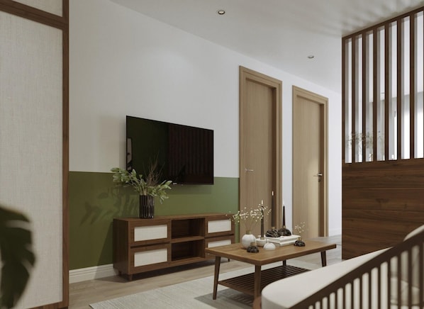 A modern living room with a wooden TV stand, a green accent wall, and a wooden staircase. - Nature Hotel (Xuan Huong - Da Lat)