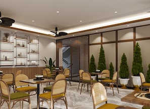 A restaurant interior with multiple dining tables and chairs, a staircase, and decorative plants. - Nature Hotel (Xuan Huong - Da Lat)