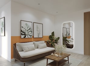 A modern living room with a sofa, a coffee table, and framed botanical prints on the wall. - Nature Hotel (Xuan Huong - Da Lat)