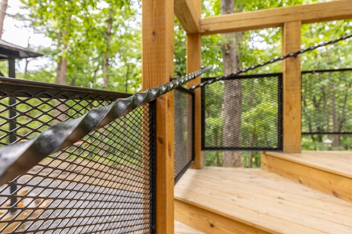 A wooden deck with a metal safety railing.