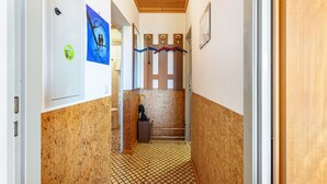A narrow hallway with cork flooring, a wooden ceiling, and a door on the left. - Apartment 'Haus Gisela Berger' with Shared Terrace, Shared Garden and Balcony (Dachsberg)