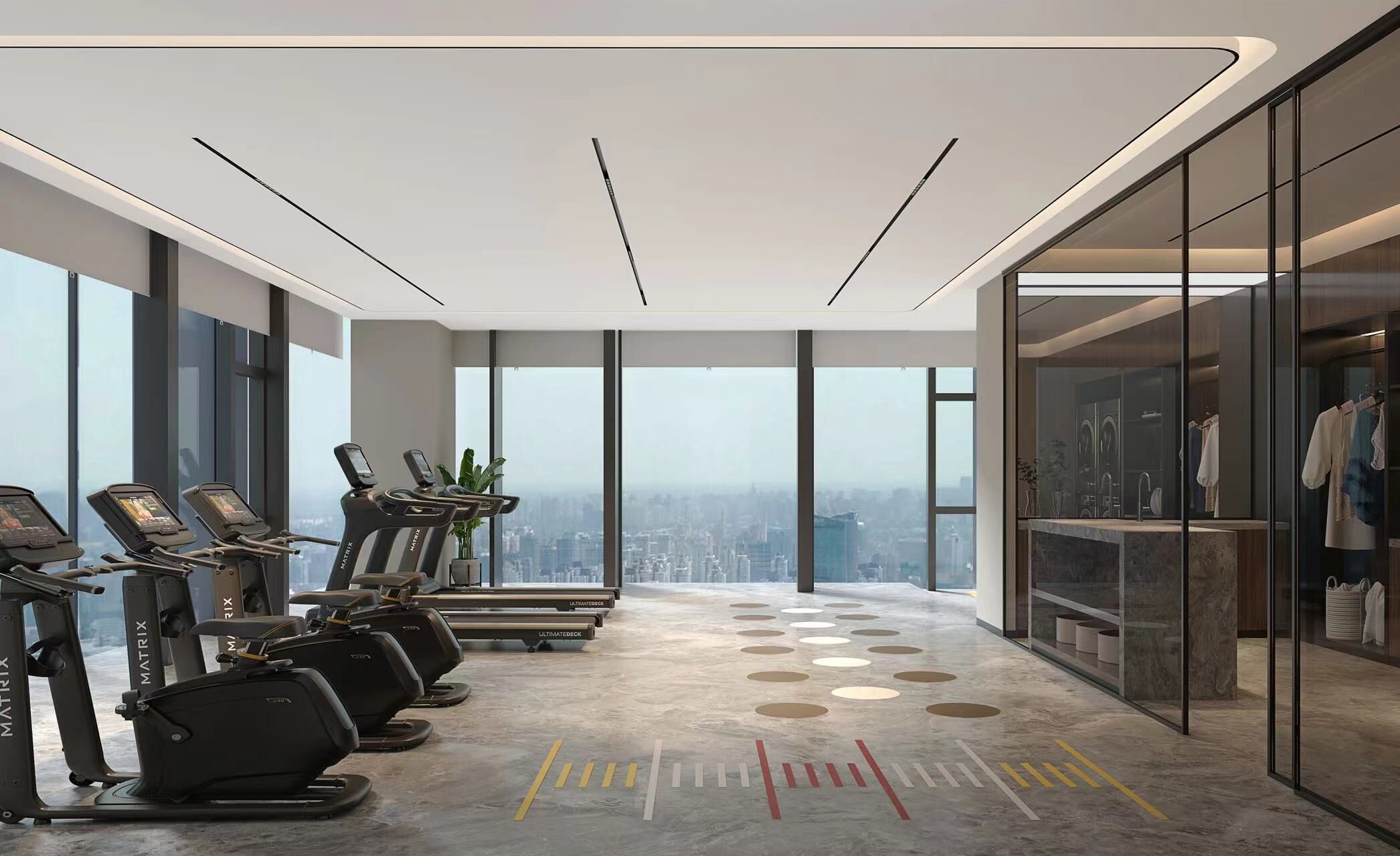 A modern gym with treadmills, a city view, and a glass-enclosed changing room.