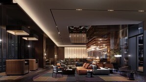 A modern interior with a lounge area featuring sofas, a coffee table, and a bar with shelves of bottles.
