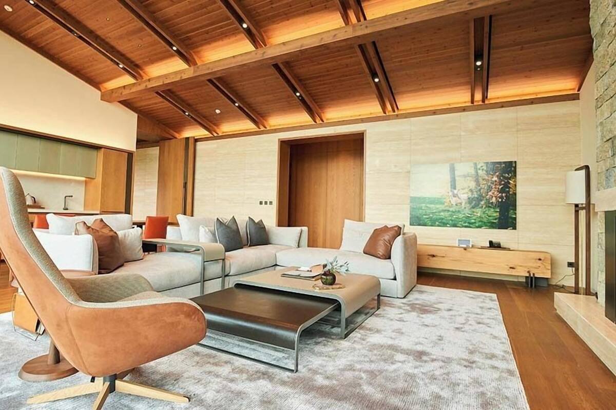 A modern living room with a sectional sofa, a leather chair, and a coffee table.