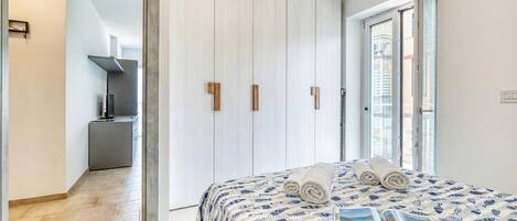 Un dormitorio con una cama, un libro y vistas al exterior.