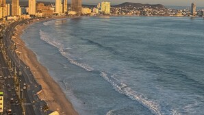 A coastal cityscape with a wide beach, high-rise buildings, and a clear sky. - ALOHA MAZATLAN (Mazatlán)