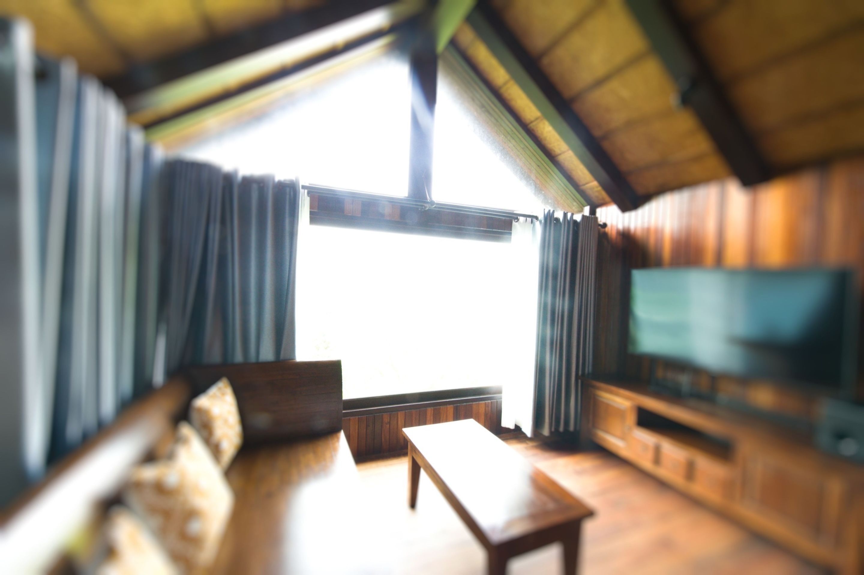 A living room with a sofa, a coffee table, and a television.