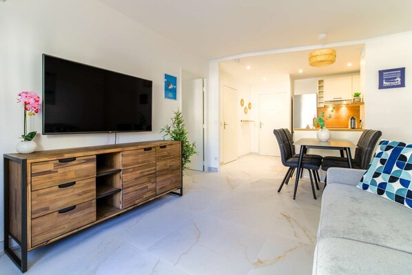 Relax in this stylish living room with a flat-screen TV, console table, and comfortable sofa.