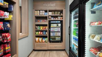 A grocery store with shelves stocked with snacks, beverages, and packaged goods.
