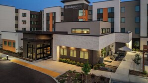 A modern hotel with a flat roof, large windows, and a sign reading "Residence Inn by Marriott". - Residence Inn by Marriott Sacramento Cal Expo (Sacramento)