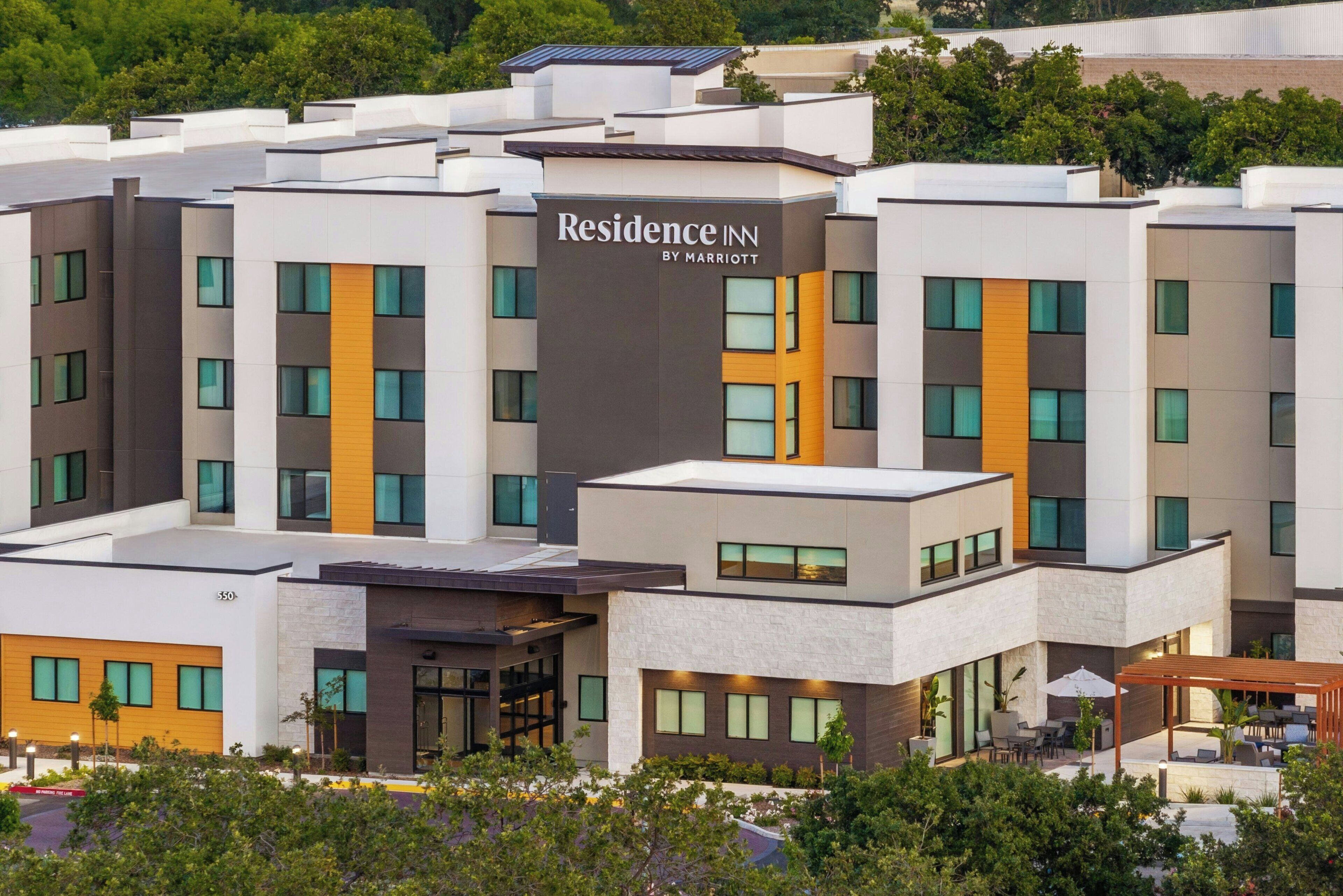 A multi-story hotel with a modern design, featuring a prominent signage for 'Residence Inn by Marriott'.