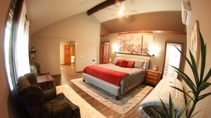 A bedroom with a bed, a chair, a nightstand, a plant, and a ceiling fan. - Gorgeous Executive Home - Hot Tub, Gym, Theatre, and More! (Spokane)