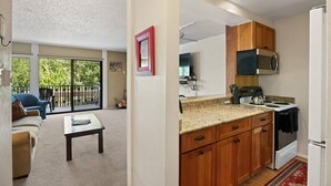 A modern kitchen with wooden cabinets, a granite countertop, and a built-in microwave. - Snowmass Base Village Retreat. Great View W/ Balcony! Grill/Hot Tub/Pool/Parking. Monthly Rates! (Snowmass Village)