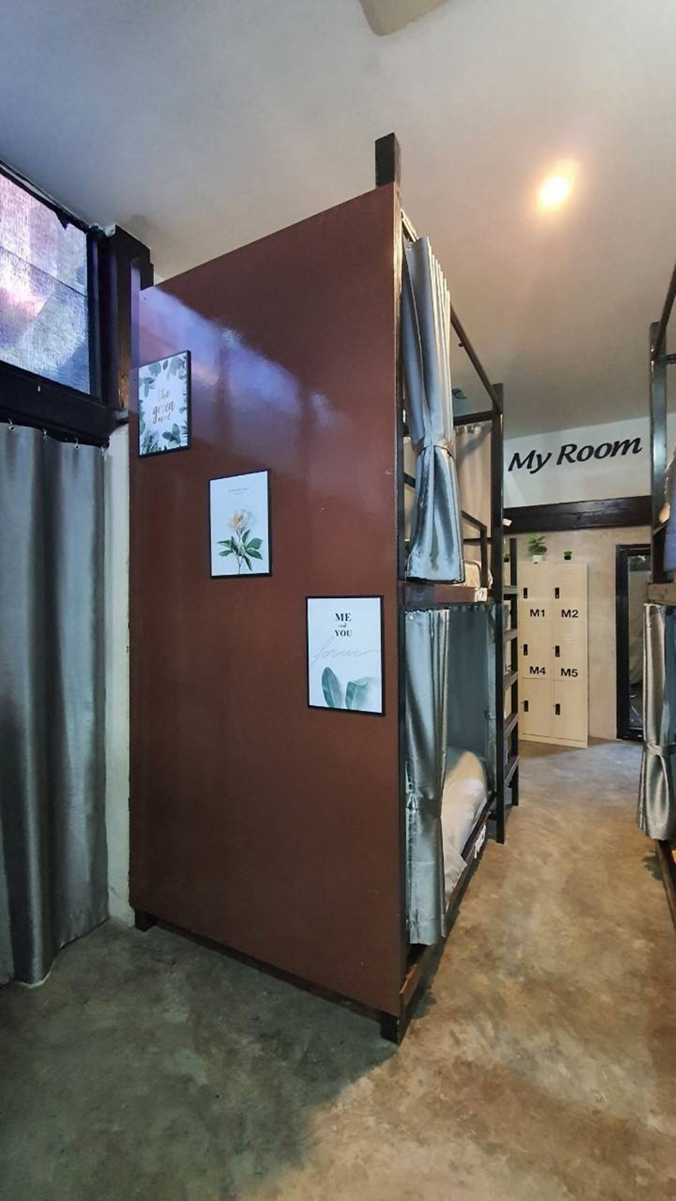 A room with a brown cabinet, a bed with a grey cover, and a door labeled "My Room".