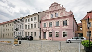 A street with historic buildings, a cobblestone road, and parked cars. - Apartment 'Ferienwohnung 3' with Shared Terrace and Wi-Fi (Luckau)