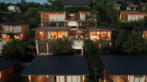 A multi-story resort with outdoor seating and a hot tub. - Ocean View Villas by Grun (Pecatu)